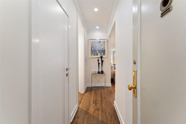 hall featuring ornamental molding, dark wood finished floors, baseboards, and recessed lighting