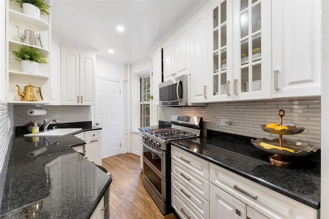 kitchen with appliances with stainless steel finishes, open shelves, white cabinets, tasteful backsplash, and recessed lighting