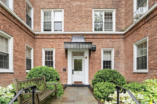 view of exterior entry with brick siding