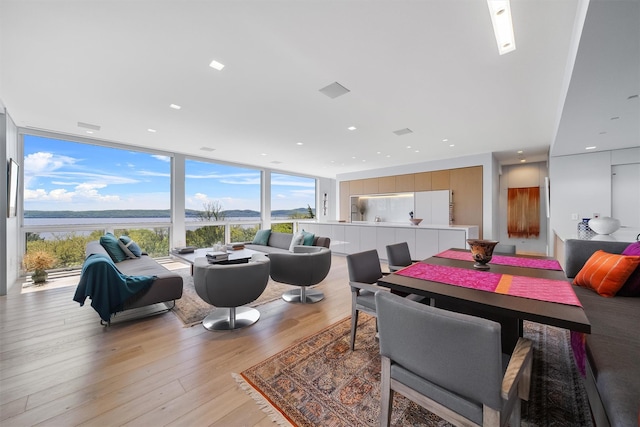 26 Mount Green Rd, Croton-On-Hudson, NY 10520 - dining room with a wall of windows, a water view, light wood-style flooring, and recessed lighting