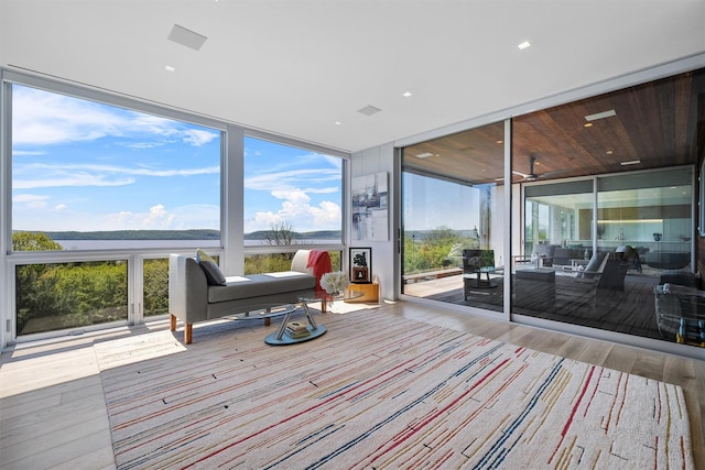26 Mount Green Rd, Croton-On-Hudson, NY 10520 - sunroom featuring a water view, wood finished floors, and a wall of windows