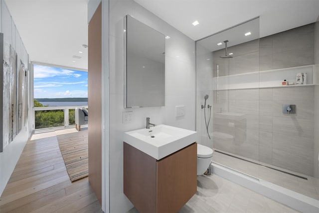 26 Mount Green Rd, Croton-On-Hudson, NY 10520 - bathroom featuring vanity, a tile shower, toilet, floor to ceiling windows, and a water view