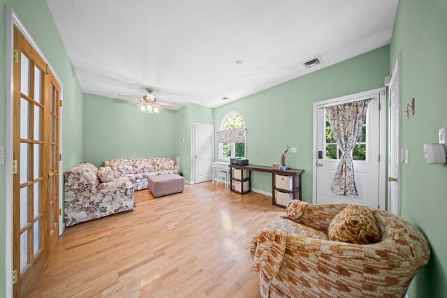 9 Fairwind Ct, Oakdale, NY 11769 - living area with wood finished floors and a ceiling fan