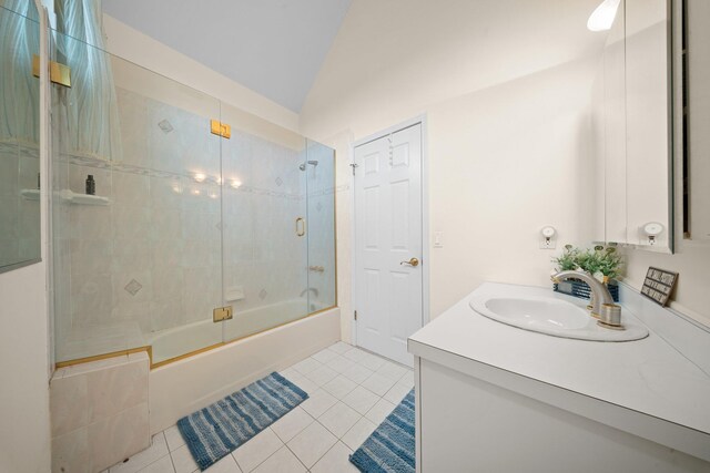 9 Fairwind Ct, Oakdale, NY 11769 - full bathroom with tile patterned floors, shower / bath combination with glass door, vaulted ceiling, and vanity