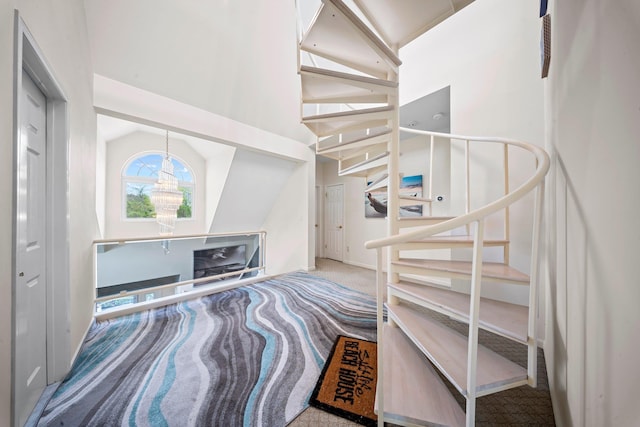 9 Fairwind Ct, Oakdale, NY 11769 - staircase with carpet and high vaulted ceiling