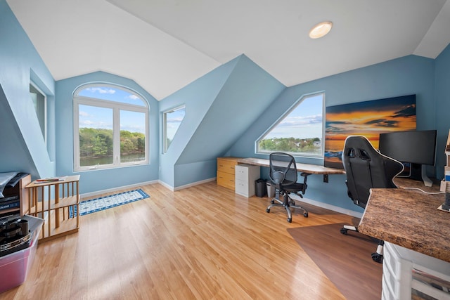 9 Fairwind Ct, Oakdale, NY 11769 - home office with lofted ceiling, light wood-type flooring, and baseboards