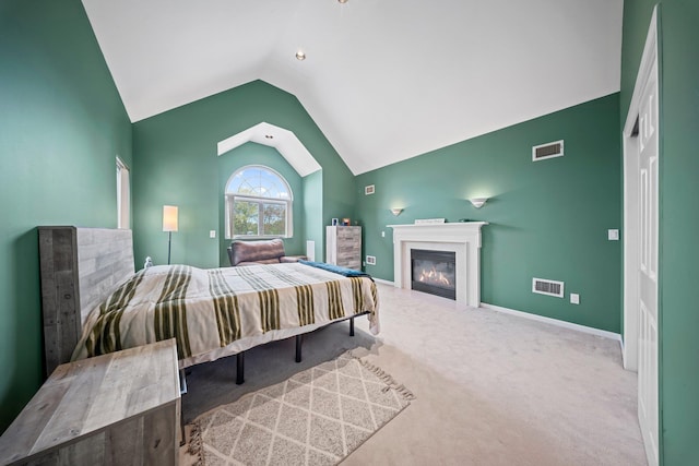 9 Fairwind Ct, Oakdale, NY 11769 - carpeted bedroom featuring lofted ceiling, a glass covered fireplace, and baseboards