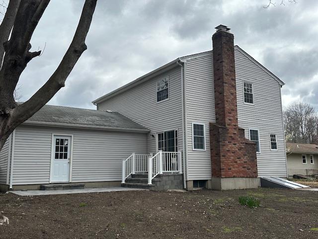 rear view of property with a chimney
