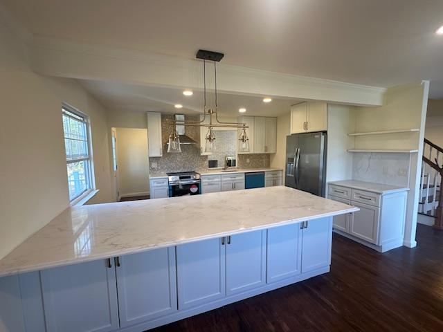 kitchen featuring black refrigerator with ice dispenser, open shelves, wall chimney range hood, a peninsula, and stainless steel range oven