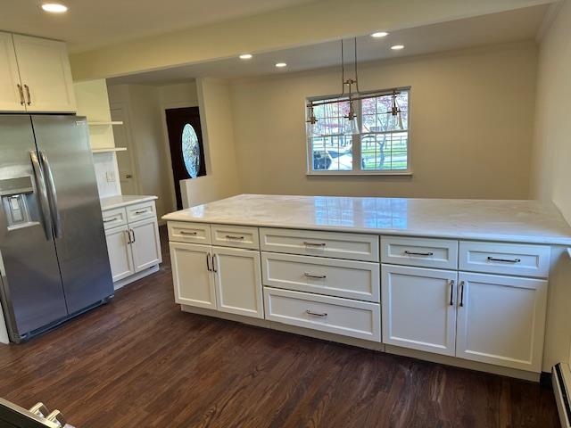 kitchen with stainless steel fridge, dark wood-type flooring, white cabinetry, and recessed lighting