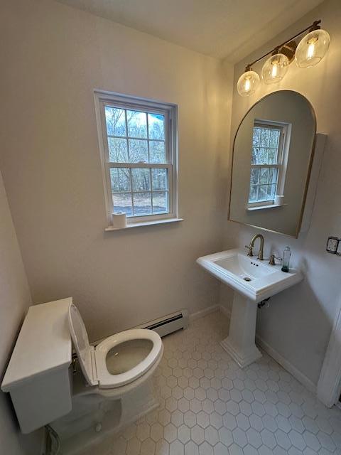 bathroom with toilet and baseboards