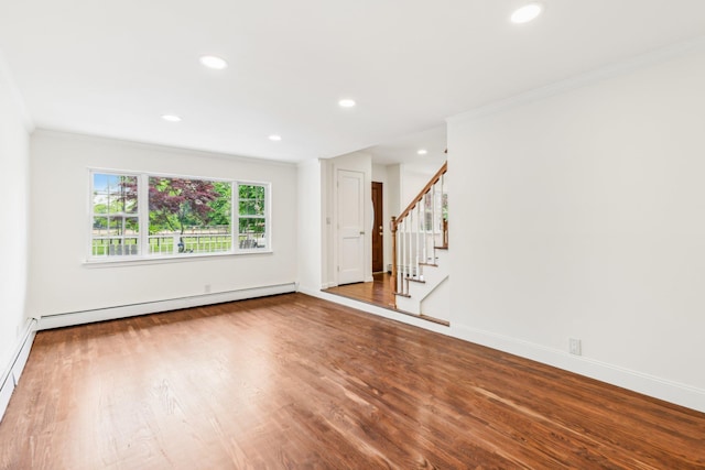 8 Mill Lot Rd, Middle Island, NY 11953 - spare room featuring baseboard heating, crown molding, recessed lighting, wood finished floors, and stairs