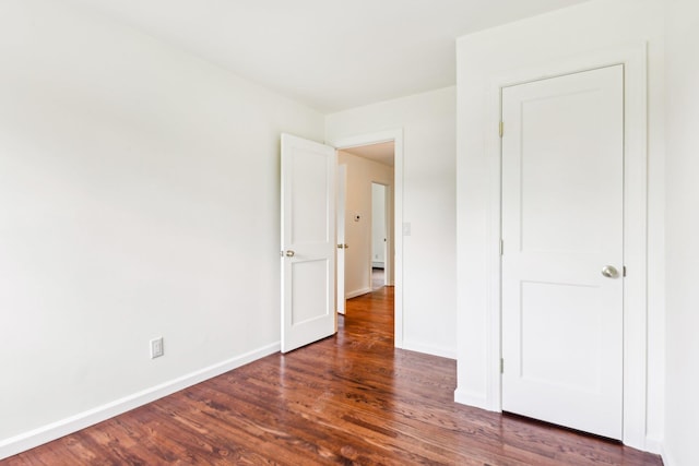 8 Mill Lot Rd, Middle Island, NY 11953 - unfurnished bedroom with wood finished floors and baseboards