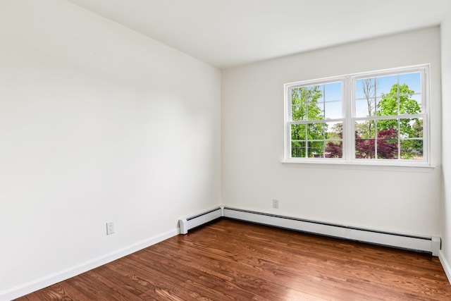 8 Mill Lot Rd, Middle Island, NY 11953 - empty room featuring baseboard heating, wood finished floors, and baseboards