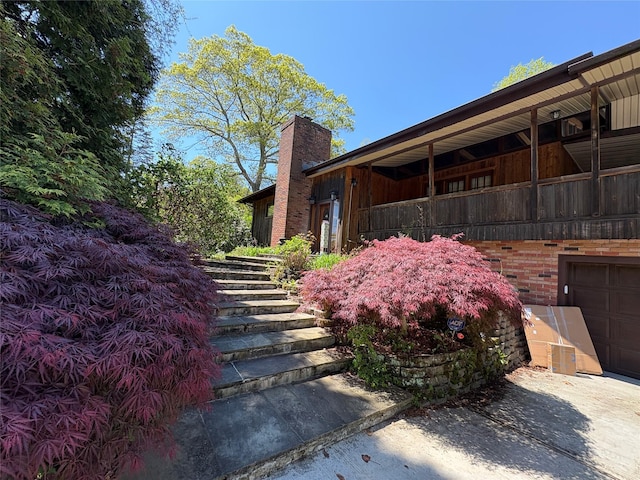 6 Annette Ln, East Moriches, NY 11940 - view of side of home with a chimney and stairway