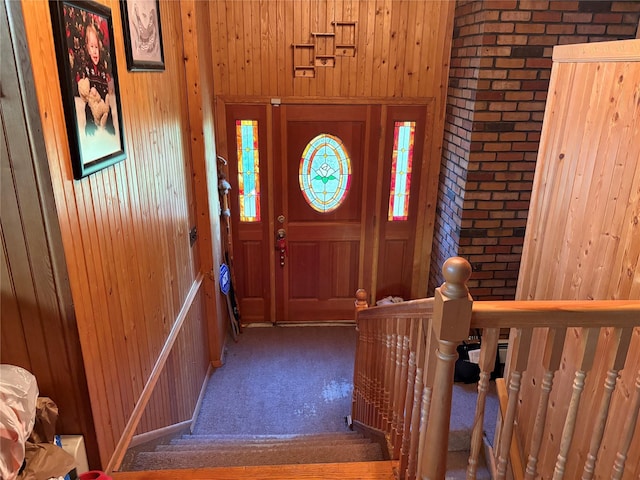 6 Annette Ln, East Moriches, NY 11940 - foyer entrance featuring wooden walls, brick wall, and carpet