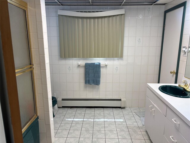 6 Annette Ln, East Moriches, NY 11940 - full bath with a baseboard radiator, tile walls, vanity, a shower with door, and tile patterned floors