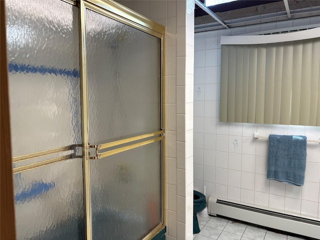 6 Annette Ln, East Moriches, NY 11940 - bathroom with a baseboard radiator, tile walls, a shower stall, and tile patterned flooring