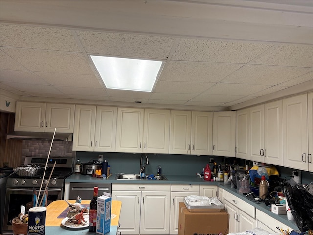 6 Annette Ln, East Moriches, NY 11940 - kitchen featuring a sink, gas stove, a paneled ceiling, dishwasher, and white cabinets
