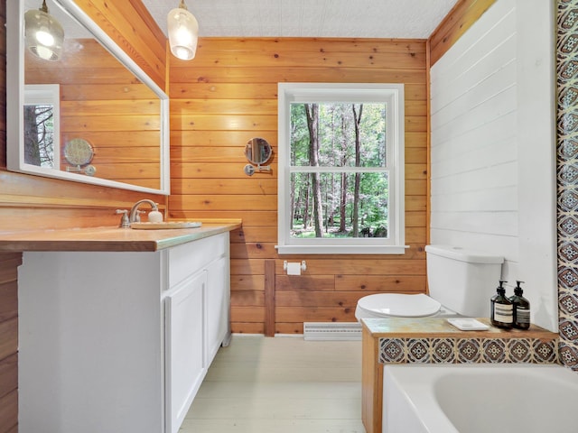 60 Park Road Ext, Eldred, NY 12792 - bathroom with wood walls, vanity, a bath, and a baseboard radiator