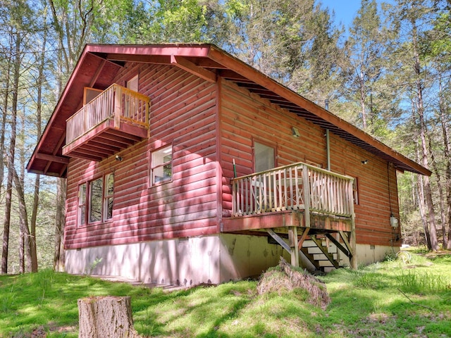 60 Park Road Ext, Eldred, NY 12792 - view of home's exterior with a balcony, a lawn, and faux log siding