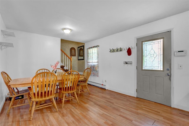 24 Haynes Ave, West Islip, NY 11795 - dining area with a baseboard radiator, light wood-type flooring, stairway, and baseboards