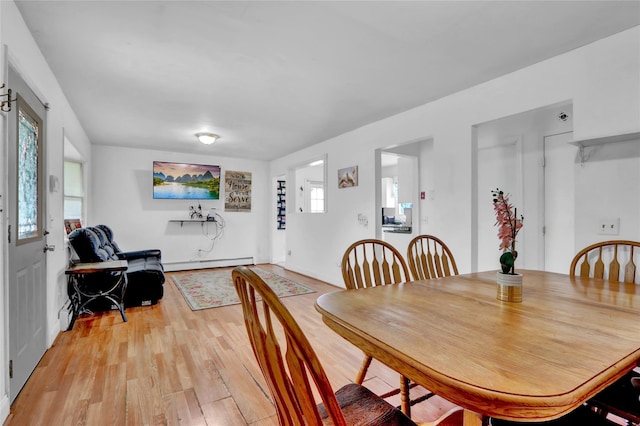 24 Haynes Ave, West Islip, NY 11795 - dining area with baseboard heating, plenty of natural light, and light wood-style floors