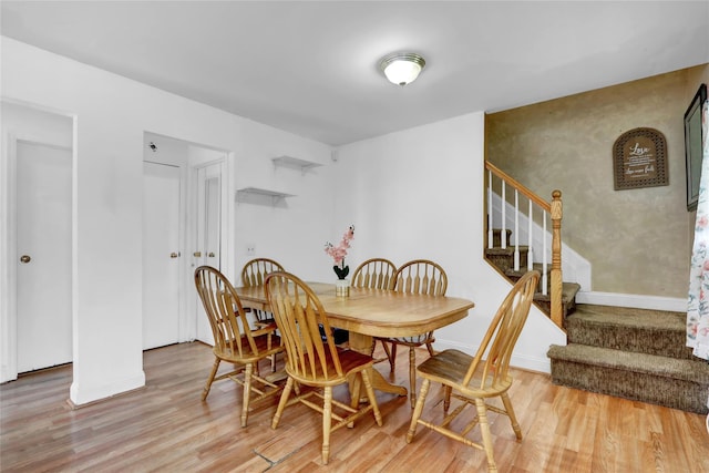 24 Haynes Ave, West Islip, NY 11795 - dining room featuring light wood-type flooring, stairs, and baseboards