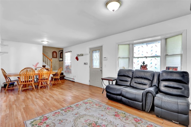 24 Haynes Ave, West Islip, NY 11795 - living room with stairway, light wood-style flooring, and a baseboard heating unit