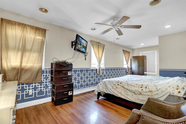 24 Haynes Ave, West Islip, NY 11795 - bedroom featuring baseboard heating, a wainscoted wall, wood finished floors, a ceiling fan, and recessed lighting