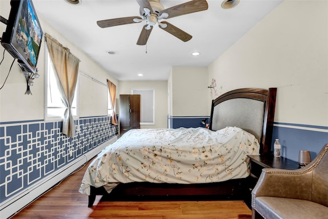 24 Haynes Ave, West Islip, NY 11795 - bedroom with a baseboard radiator, wainscoting, wood finished floors, a ceiling fan, and recessed lighting