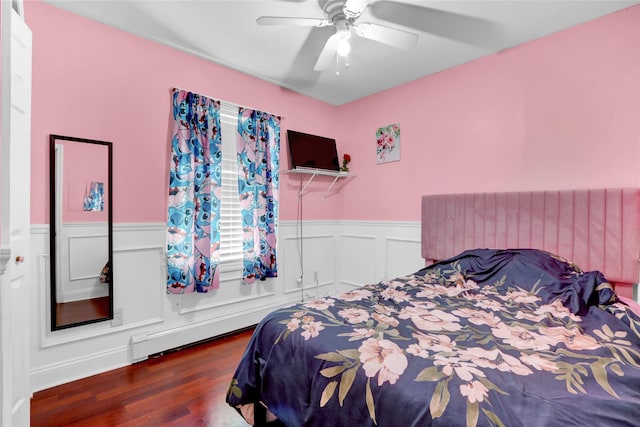 24 Haynes Ave, West Islip, NY 11795 - bedroom with wainscoting, wood finished floors, ceiling fan, a baseboard radiator, and a decorative wall