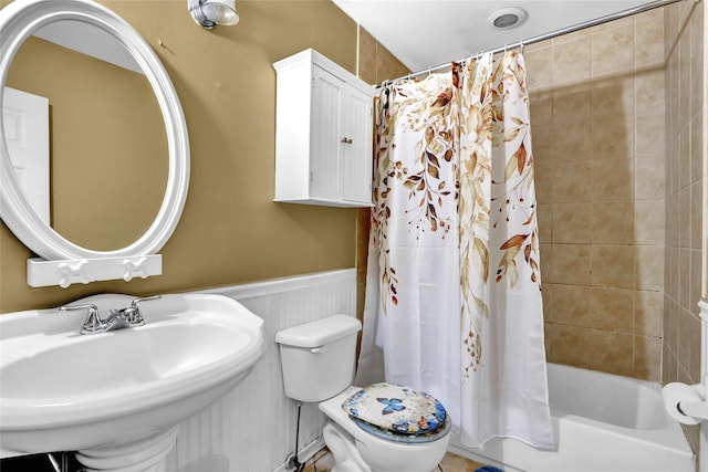 24 Haynes Ave, West Islip, NY 11795 - bathroom featuring a wainscoted wall, a sink, toilet, and shower / bath combo