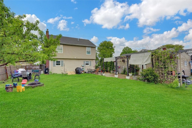 24 Haynes Ave, West Islip, NY 11795 - rear view of property featuring a chimney, a fire pit, and a patio