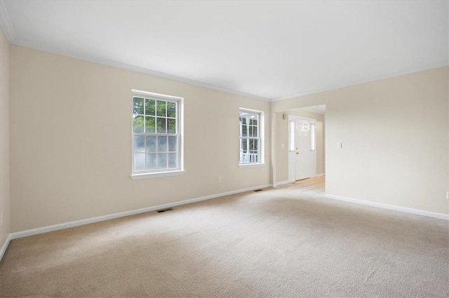 unfurnished room featuring light colored carpet and baseboards