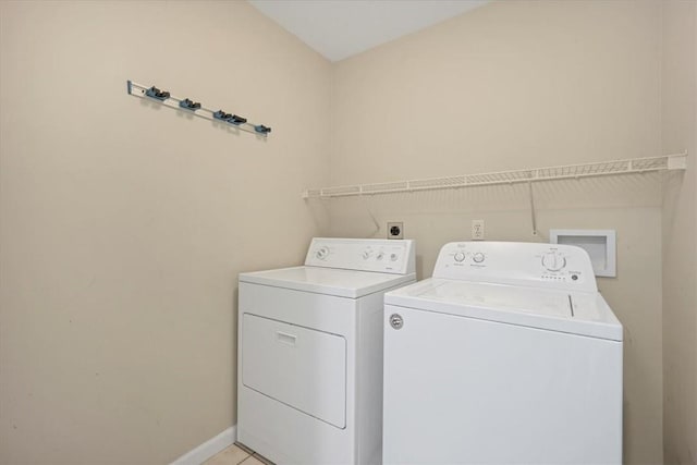 laundry room featuring washer and dryer and baseboards