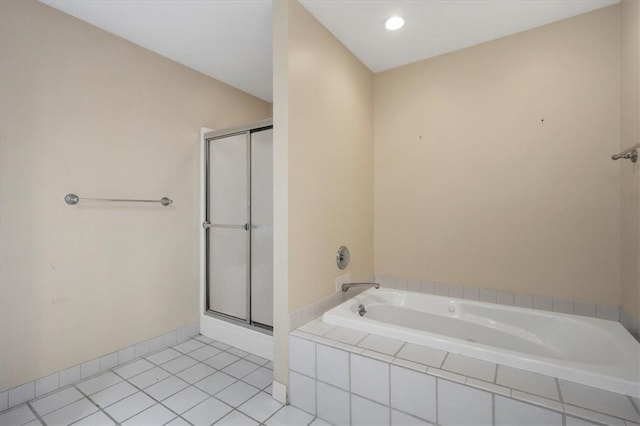 bathroom with a stall shower, a bath, and tile patterned flooring