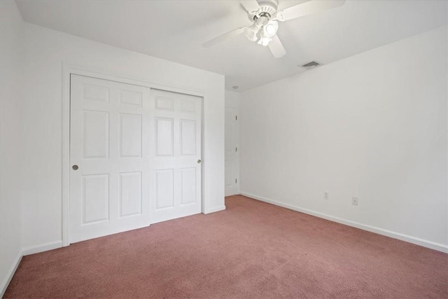 unfurnished bedroom with carpet floors, a closet, and baseboards