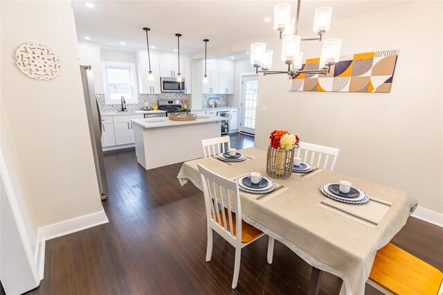 dining area featuring dark wood-style floors, a chandelier, recessed lighting, and plenty of natural light