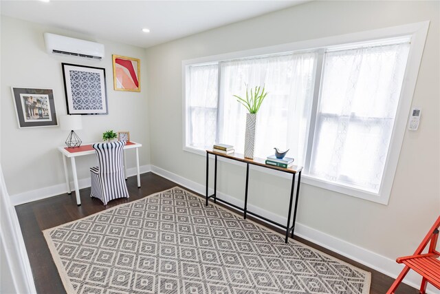 home office with a wall mounted AC, wood finished floors, baseboards, and recessed lighting