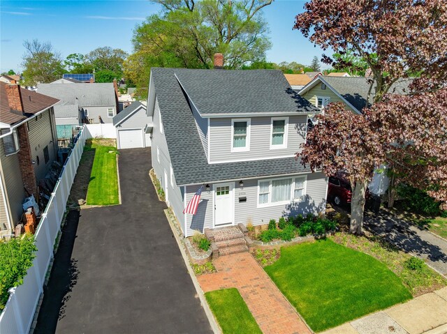 traditional home featuring a shingled roof, a garage, and a chimney