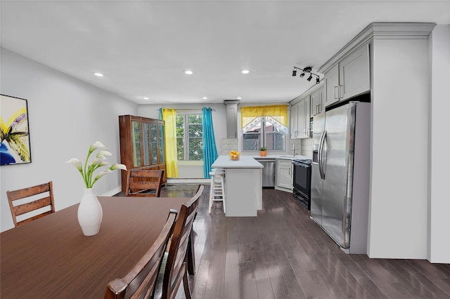 dining space with dark wood-style flooring and recessed lighting