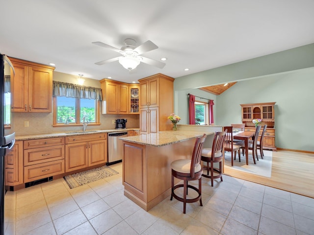 229 Eldred Yulan Rd, Eldred, NY 12792 - kitchen featuring dishwasher, a breakfast bar area, healthy amount of natural light, decorative backsplash, and recessed lighting