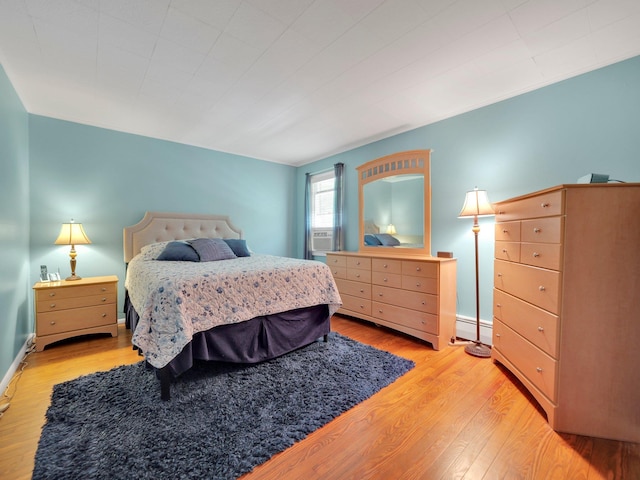 229 Eldred Yulan Rd, Eldred, NY 12792 - bedroom with light wood-style flooring, a baseboard radiator, cooling unit, and baseboards