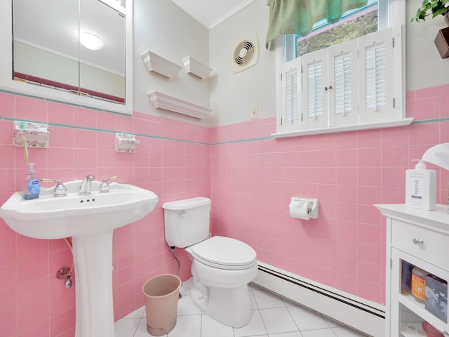 229 Eldred Yulan Rd, Eldred, NY 12792 - half bathroom with baseboard heating, tile walls, tile patterned floors, toilet, and ornamental molding