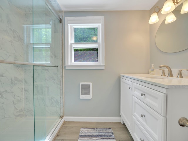 229 Eldred Yulan Rd, Eldred, NY 12792 - full bathroom with vanity, heating unit, a marble finish shower, wood finished floors, and baseboards