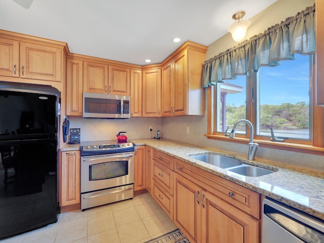 229 Eldred Yulan Rd, Eldred, NY 12792 - kitchen featuring stainless steel appliances, a sink, light stone counters, light tile patterned floors, and recessed lighting