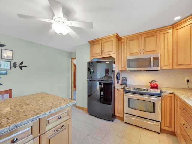 229 Eldred Yulan Rd, Eldred, NY 12792 - kitchen featuring appliances with stainless steel finishes, decorative backsplash, light stone counters, a ceiling fan, and light tile patterned floors