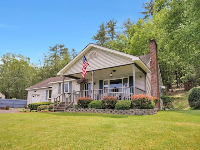 229 Eldred Yulan Rd, Eldred, NY 12792 - view of front of home with a porch, a chimney, a front yard, and a garage