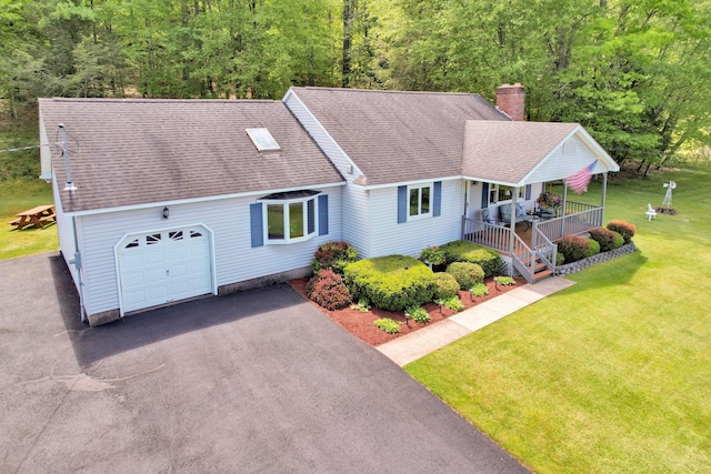 229 Eldred Yulan Rd, Eldred, NY 12792 - view of front of house featuring covered porch, a chimney, an attached garage, a shingled roof, and a front yard